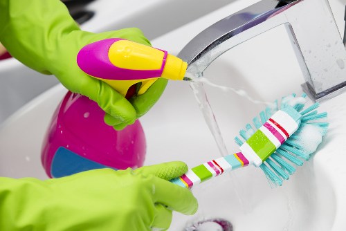 Cleaner inspecting a carpet stain before treatment begins